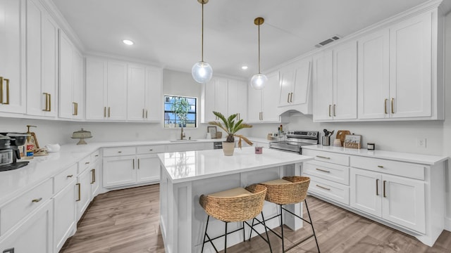 1381 County Road 1470, Chico, TX 76431 - kitchen featuring stainless steel electric range, white cabinets, light countertops, a kitchen bar, and recessed lighting
