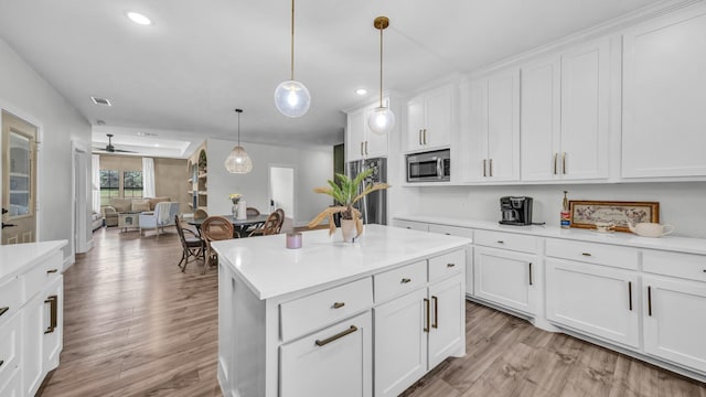 1381 County Road 1470, Chico, TX 76431 - kitchen with stainless steel microwave, recessed lighting, light countertops, and white cabinetry
