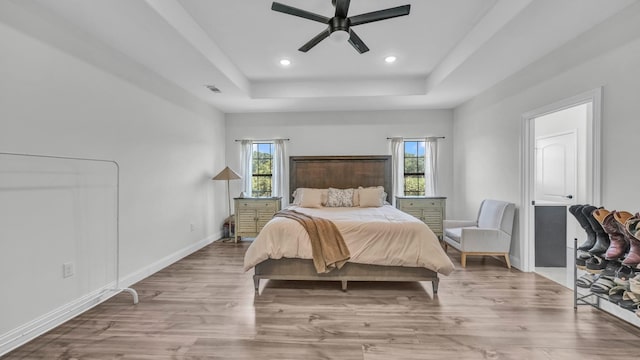 1381 County Road 1470, Chico, TX 76431 - bedroom featuring multiple windows, a tray ceiling, wood finished floors, recessed lighting, and ceiling fan