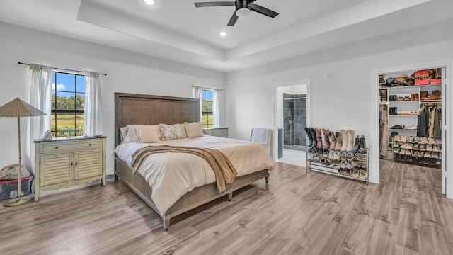 1381 County Road 1470, Chico, TX 76431 - bedroom with a tray ceiling, wood finished floors, recessed lighting, a walk in closet, and a closet