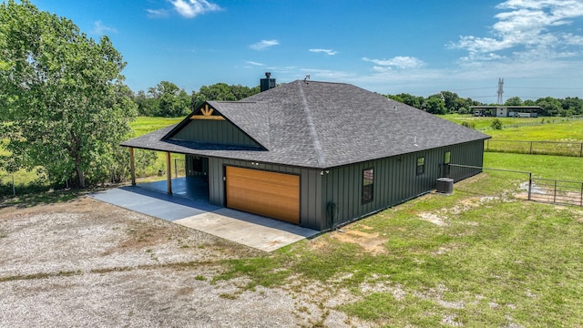 1381 County Road 1470, Chico, TX 76431 - view of home's exterior featuring roof with shingles, board and batten siding, dirt driveway, and a chimney