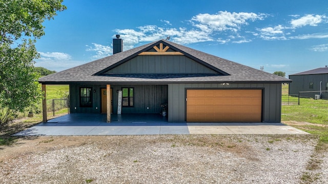 1381 County Road 1470, Chico, TX 76431 - view of front of home featuring roof with shingles, covered porch, a chimney, and an attached garage