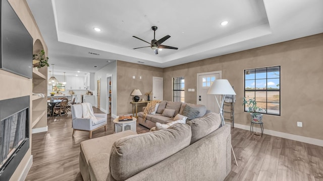 1381 County Road 1470, Chico, TX 76431 - living room featuring a raised ceiling, a ceiling fan, wood finished floors, and recessed lighting