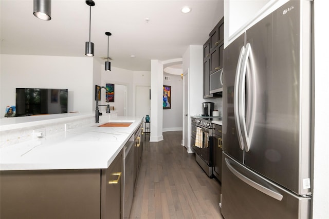 4333 Gilbert Ave Unit 330, Dallas, TX 75219 - kitchen with appliances with stainless steel finishes, dark wood-style flooring, light stone counters, decorative light fixtures, and recessed lighting