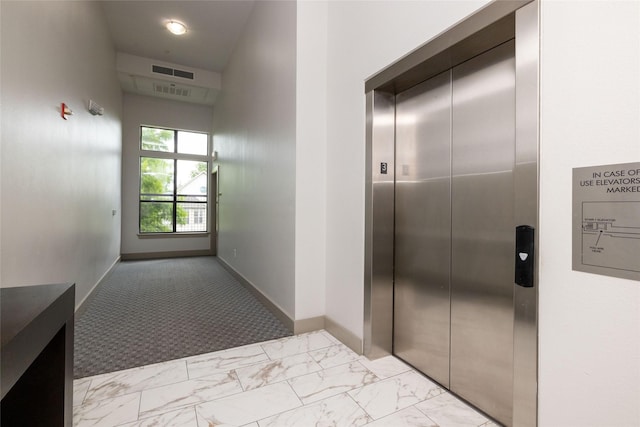 4333 Gilbert Ave Unit 330, Dallas, TX 75219 - corridor featuring elevator and light marble finish flooring