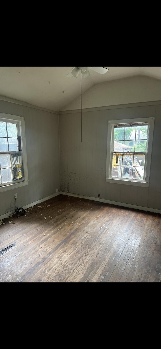 1026 Peak St, Denton, TX 76201 - spare room featuring wood-type flooring, healthy amount of natural light, lofted ceiling, and ceiling fan