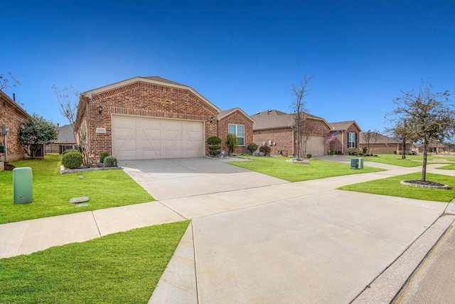 7616 Heritage Dr, Little Elm, TX 76227 - view of front of home featuring brick siding, a garage, a front yard, and driveway