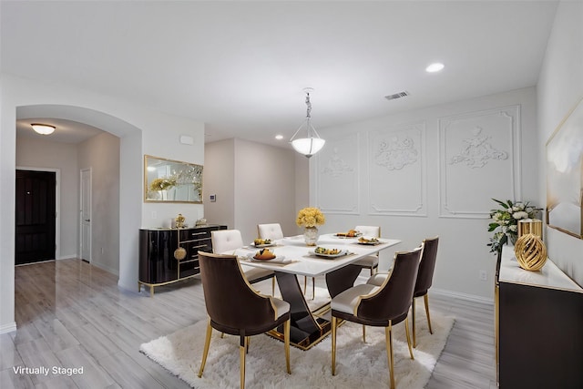 7616 Heritage Dr, Little Elm, TX 76227 - dining room with arched walkways, light wood-style flooring, and recessed lighting