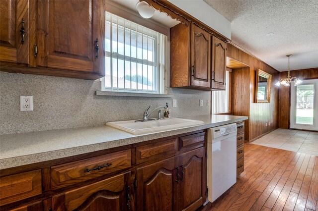 328 Bennett Cir, Desoto, TX 75115 - kitchen featuring dishwasher, light wood finished floors, decorative backsplash, light countertops, and decorative light fixtures