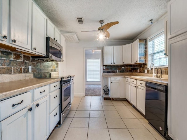 3836 Diamond Loch E, North Richland Hills, TX 76180 - kitchen with appliances with stainless steel finishes, ceiling fan, white cabinets, decorative backsplash, and a textured ceiling
