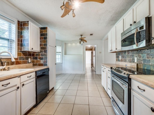 3836 Diamond Loch E, North Richland Hills, TX 76180 - kitchen with appliances with stainless steel finishes, a ceiling fan, a textured ceiling, decorative backsplash, and light countertops