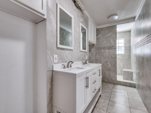3836 Diamond Loch E, North Richland Hills, TX 76180 - full bathroom with double vanity, tile patterned floors, tile walls, and a tile shower