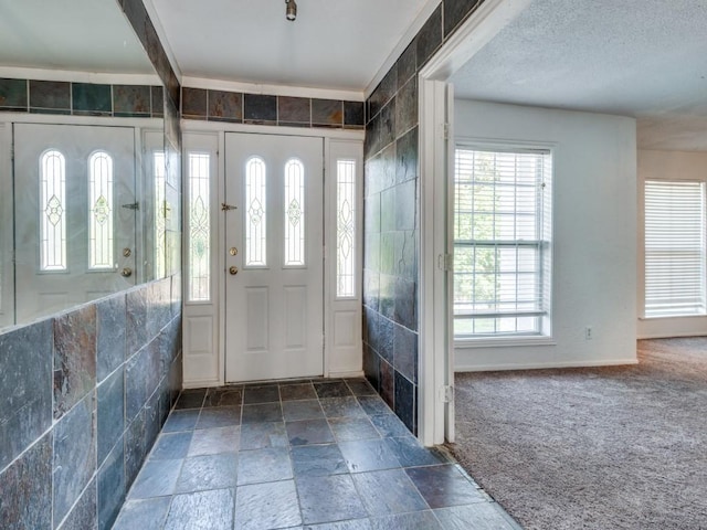 3836 Diamond Loch E, North Richland Hills, TX 76180 - entrance foyer with stone tile flooring and carpet floors