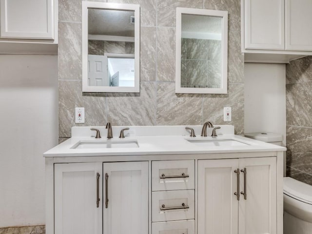 3836 Diamond Loch E, North Richland Hills, TX 76180 - bathroom with tile walls, double vanity, and tasteful backsplash
