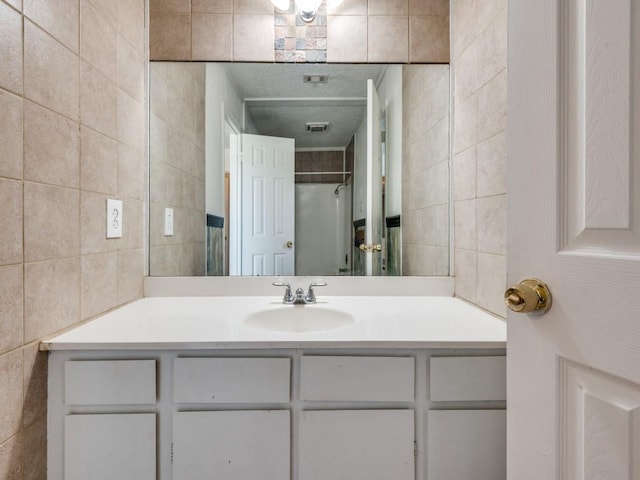3836 Diamond Loch E, North Richland Hills, TX 76180 - bathroom featuring tile walls and vanity