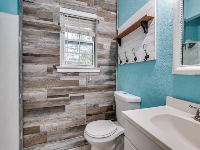 3836 Diamond Loch E, North Richland Hills, TX 76180 - bathroom with a textured wall, vanity, and wood walls