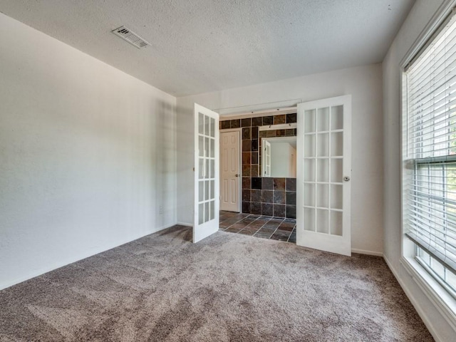 3836 Diamond Loch E, North Richland Hills, TX 76180 - unfurnished room with french doors, carpet flooring, and a textured ceiling