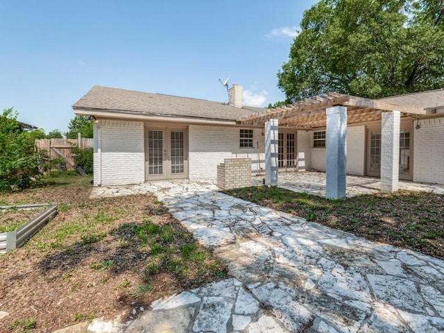 3836 Diamond Loch E, North Richland Hills, TX 76180 - back of property with french doors, a patio, brick siding, a pergola, and a chimney