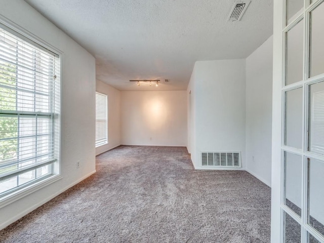 3836 Diamond Loch E, North Richland Hills, TX 76180 - carpeted spare room featuring a textured ceiling and track lighting