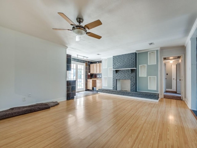 3836 Diamond Loch E, North Richland Hills, TX 76180 - unfurnished living room with light wood-style floors, ceiling fan, and a fireplace