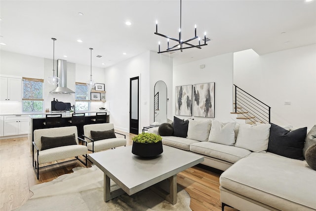 354 Foch St, Fort Worth, TX 76107 - living area featuring light wood-style flooring, a chandelier, recessed lighting, and stairs
