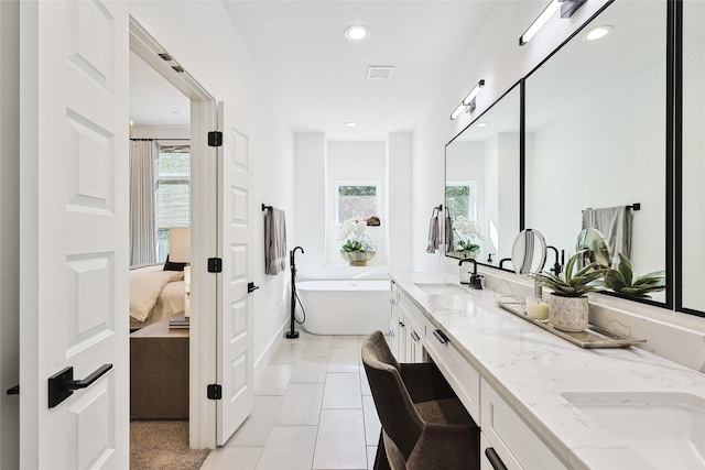 354 Foch St, Fort Worth, TX 76107 - ensuite bathroom with plenty of natural light, double vanity, a freestanding tub, recessed lighting, and tile patterned flooring
