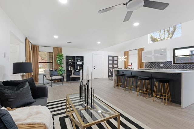 10669 Larchfield Ln, Dallas, TX 75238 - living room featuring light wood-type flooring, recessed lighting, a ceiling fan, and vaulted ceiling