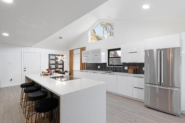 10669 Larchfield Ln, Dallas, TX 75238 - kitchen with freestanding refrigerator, modern cabinets, white cabinets, light wood-style flooring, and high vaulted ceiling