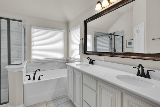 513 Endicott Dr, Sherman, TX 75092 - bathroom featuring vaulted ceiling, a bath, a shower stall, and double vanity