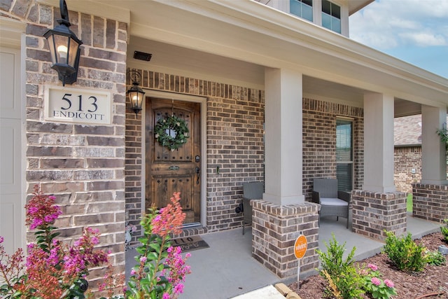 513 Endicott Dr, Sherman, TX 75092 - view of exterior entry featuring covered porch and brick siding