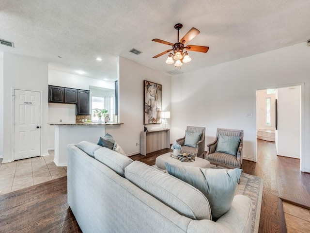 1728 Forest Glen Dr, Flower Mound, TX 75028 - living area featuring a ceiling fan, wood finished floors, a textured ceiling, and recessed lighting