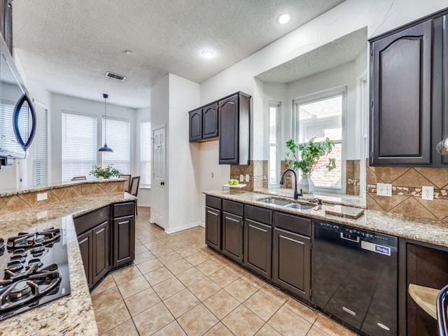 1728 Forest Glen Dr, Flower Mound, TX 75028 - kitchen featuring black appliances, healthy amount of natural light, tasteful backsplash, a textured ceiling, and recessed lighting