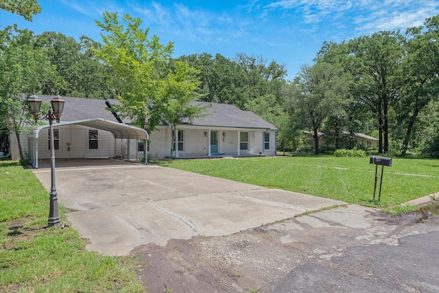 213 N Oaks Dr, Grand Saline, TX 75140 - view of front of property featuring concrete driveway, a front yard, a porch, and a carport