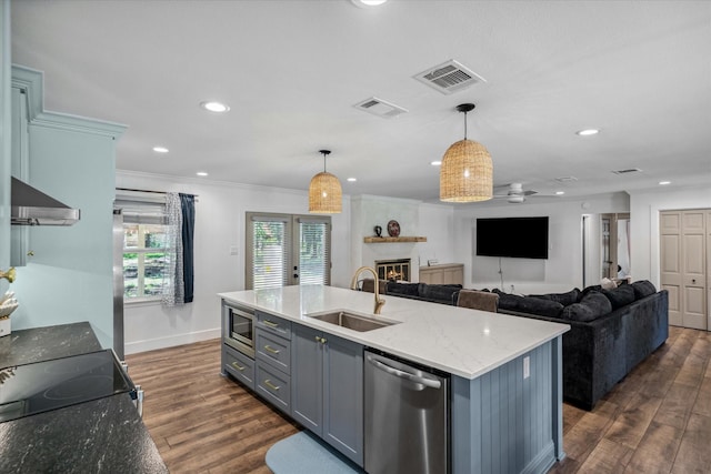 213 N Oaks Dr, Grand Saline, TX 75140 - kitchen featuring stainless steel appliances, a fireplace, range hood, dark wood-style floors, and recessed lighting