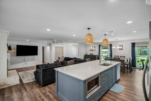 213 N Oaks Dr, Grand Saline, TX 75140 - kitchen with appliances with stainless steel finishes, dark wood-style flooring, hanging light fixtures, recessed lighting, and a center island with sink