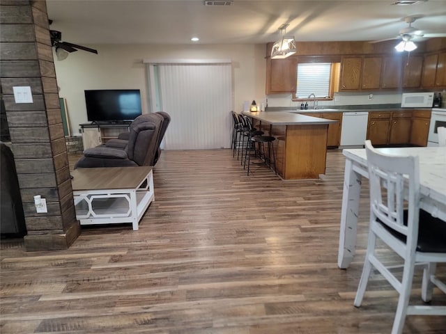 800 County Road 1030, Mount Pleasant, TX 75455 - kitchen with white appliances, a ceiling fan, open floor plan, a peninsula, and wood finished floors