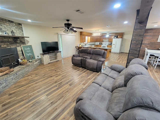 800 County Road 1030, Mount Pleasant, TX 75455 - living room with ceiling fan, light wood-style flooring, a brick fireplace, and recessed lighting