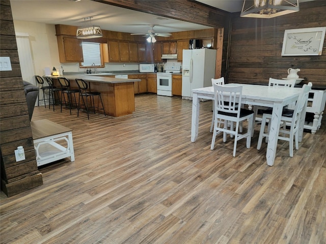 800 County Road 1030, Mount Pleasant, TX 75455 - dining space featuring wood finished floors, wooden walls, ceiling fan, and a chandelier