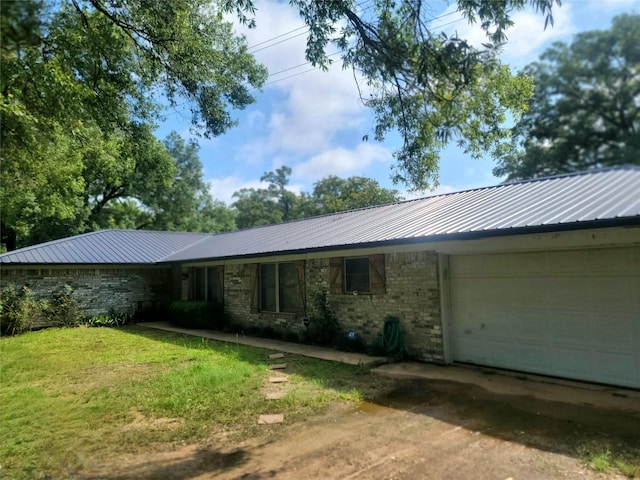 800 County Road 1030, Mount Pleasant, TX 75455 - single story home with an attached garage, a metal roof, driveway, and a front lawn