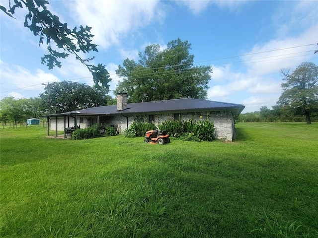 800 County Road 1030, Mount Pleasant, TX 75455 - back of property with a lawn, a metal roof, and a chimney