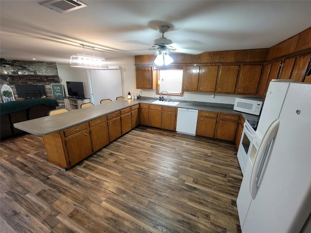 800 County Road 1030, Mount Pleasant, TX 75455 - kitchen featuring white appliances, ceiling fan, a peninsula, brown cabinetry, and dark wood finished floors