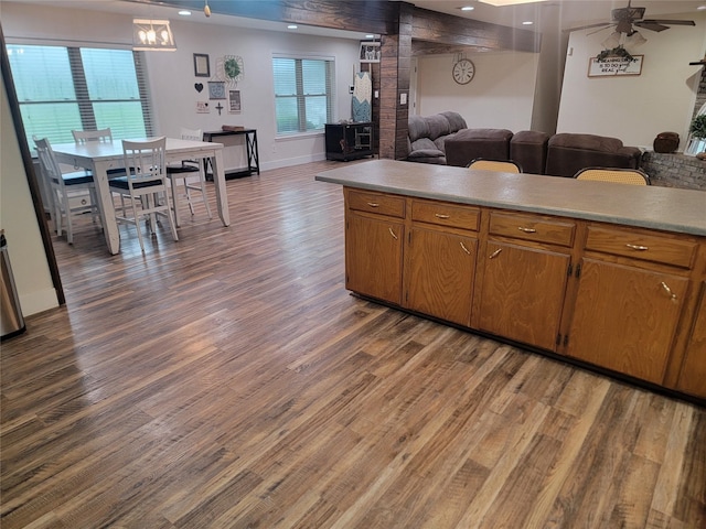 800 County Road 1030, Mount Pleasant, TX 75455 - kitchen featuring open floor plan, dark wood-type flooring, light countertops, ceiling fan, and brown cabinetry