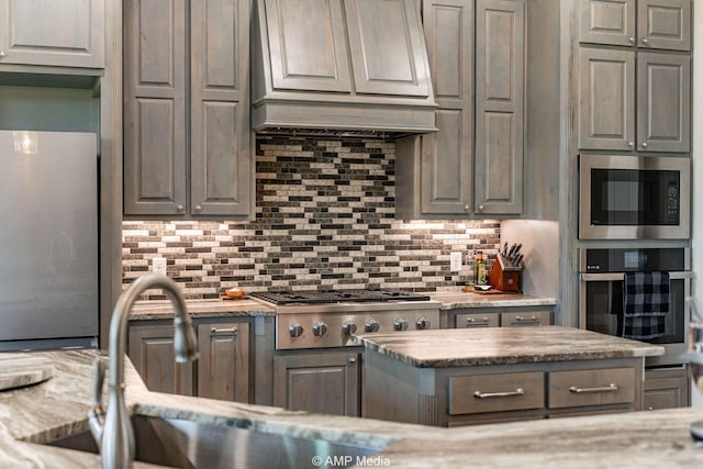 408 Lake Arbor Dr, Weatherford, TX 76088 - kitchen featuring appliances with stainless steel finishes, custom exhaust hood, tasteful backsplash, and light stone countertops