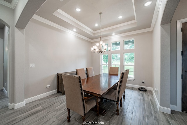 408 Lake Arbor Dr, Weatherford, TX 76088 - dining area featuring a tray ceiling, light wood-style floors, a chandelier, arched walkways, and recessed lighting