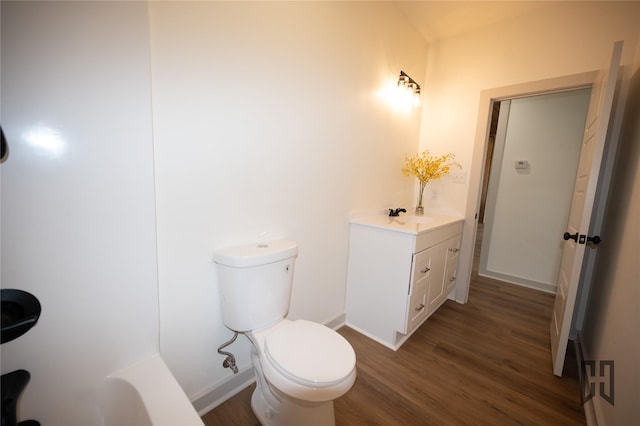 719 Germantown Rd, Minden, LA 71055 - full bathroom with vanity, wood finished floors, and a tub to relax in