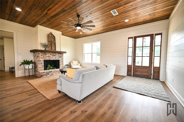 719 Germantown Rd, Minden, LA 71055 - living area with wood ceiling, ceiling fan, a fireplace, wood finished floors, and wooden walls