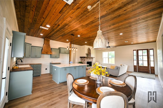 719 Germantown Rd, Minden, LA 71055 - dining area with wood ceiling, a fireplace, wood finished floors, recessed lighting, and wooden walls
