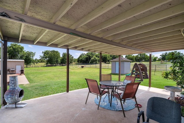 3120 Michele Ct, Weatherford, TX 76088 - fenced backyard with a storage unit, a patio area, and outdoor dining area