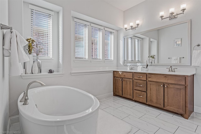 2010 Topaz Dr, Rockwall, TX 75087 - bathroom featuring marble finish flooring, double vanity, and a soaking tub