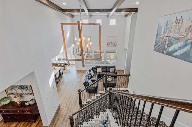 2010 Topaz Dr, Rockwall, TX 75087 - staircase with wood finished floors, beamed ceiling, a chandelier, and recessed lighting